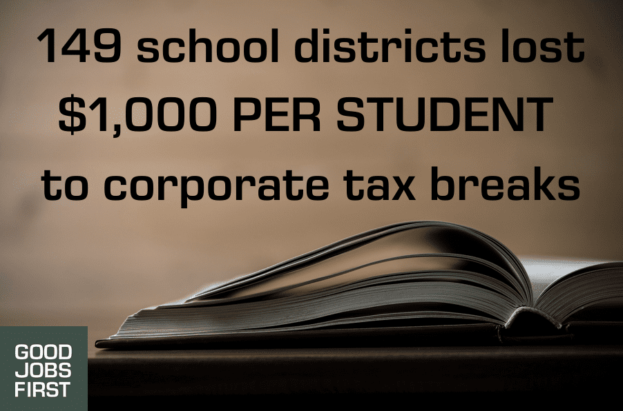 Image of textbook open, the Good Jobs First logo and the words: 149 school districts lost $1,000 PER STUDENT to corporate tax breaks
